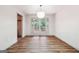 Bright dining room with hardwood floors, modern lighting, and french doors leading to the outside at 234 Kenilworth Cir, Stone Mountain, GA 30083