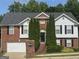 Charming two-story home with a brick facade, manicured landscaping, and an attached two-car garage at 393 Macland Dr, Lawerceville, GA 30045