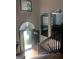Bright, two-story foyer with hardwood floors, arched doorway, and a staircase with dark wood railings at 393 Macland Dr, Lawerceville, GA 30045