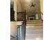Carpeted staircase leads to the upper level with dark wooden railing, and a view into the living room at 393 Macland Dr, Lawerceville, GA 30045