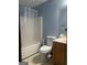 Bathroom with blue walls, shower-tub combo, and a single sink vanity at 393 Macland Dr, Lawrenceville, GA 30045