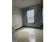 Spare bedroom featuring tile flooring, light walls, and a window at 393 Macland Dr, Lawrenceville, GA 30045