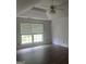 Bedroom with vaulted ceiling, ceiling fan, wood-look floors, and lots of natural light at 393 Macland Dr, Lawrenceville, GA 30045