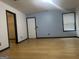 Spacious bedroom with wood floors, large window, and ample natural light at 393 Macland Dr, Lawrenceville, GA 30045