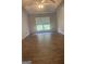 Bedroom with vaulted ceiling, ceiling fan, wood-look floors, and large windows at 393 Macland Dr, Lawrenceville, GA 30045