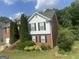 A two-story brick and siding home with a well maintained yard and shrubs at 393 Macland Dr, Lawrenceville, GA 30045