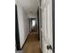 View down a hallway featuring dark trim, light walls, and hardwood floors at 393 Macland Dr, Lawrenceville, GA 30045