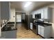 Updated kitchen featuring granite countertops, stainless steel appliances and light blue cabinets at 393 Macland Dr, Lawrenceville, GA 30045