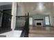 View from stairway to living room with fireplace, wood-look floors, and lots of natural light at 393 Macland Dr, Lawrenceville, GA 30045