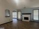 Living room with wood-look floors, brick fireplace, and lots of natural light at 393 Macland Dr, Lawrenceville, GA 30045