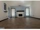 Living room with wood-look floors, brick fireplace, and access to kitchen at 393 Macland Dr, Lawrenceville, GA 30045