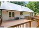 Exterior view of the back of the house, showcasing a deck, and metal roof at 3515 Chattahoochee Rd, Cumming, GA 30041