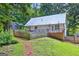 Backyard view of home with a metal roof, wooden fence, and tiered deck at 3515 Chattahoochee Rd, Cumming, GA 30041