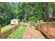 View from the deck of the backyard, which features a storage shed and a partially fenced yard at 3515 Chattahoochee Rd, Cumming, GA 30041