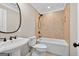 Cozy bathroom features tiled walls and floor, a bathtub, and stylish fixtures at 3515 Chattahoochee Rd, Cumming, GA 30041