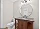 Full bathroom featuring an updated vanity with marble top and open shelving at 3515 Chattahoochee Rd, Cumming, GA 30041