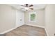 Bright bedroom with modern ceiling fan, closet and large window at 3515 Chattahoochee Rd, Cumming, GA 30041