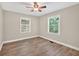 Bedroom features new hardwood floors, ceiling fan and natural light at 3515 Chattahoochee Rd, Cumming, GA 30041