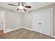 Cozy bedroom features a ceiling fan, wood-look flooring, and a closet with double doors at 3515 Chattahoochee Rd, Cumming, GA 30041