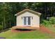Guest house exterior featuring a deck, double doors, and neutral siding at 3515 Chattahoochee Rd, Cumming, GA 30041