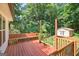 Wooden deck with built-in bench seating, looking out to the green backyard at 3515 Chattahoochee Rd, Cumming, GA 30041