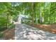 This property boasts a long driveway leading to a house nestled among mature trees at 3515 Chattahoochee Rd, Cumming, GA 30041