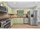 Well-appointed kitchen featuring stainless steel appliances, wooden floors and natural light at 3515 Chattahoochee Rd, Cumming, GA 30041