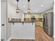 Charming kitchen featuring stainless steel appliances, tile backsplash and wooden floors at 3515 Chattahoochee Rd, Cumming, GA 30041