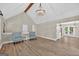 Open-concept living room with wood floors, high ceilings, and easy access to other living spaces at 3515 Chattahoochee Rd, Cumming, GA 30041