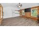 Cottage living area with wood-look flooring, wood accents, and a wall mounted TV at 3515 Chattahoochee Rd, Cumming, GA 30041