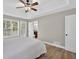 Spacious primary bedroom with wood floors and windows with wooded views at 3515 Chattahoochee Rd, Cumming, GA 30041