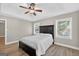 Bright bedroom features tray ceilings, ceiling fan and new hardwood flooring at 3515 Chattahoochee Rd, Cumming, GA 30041