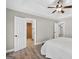 Hardwood floors in a bedroom with open doors to ensuite bathroom and closets at 3515 Chattahoochee Rd, Cumming, GA 30041