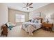 Cozy bedroom with a bed, dresser, and a bright window creating a warm and inviting atmosphere at 6142 Golf View Xing, Locust Grove, GA 30248