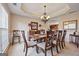 Elegant dining room featuring a chandelier, a tray ceiling, and wainscoting detail along the windows at 6142 Golf View Xing, Locust Grove, GA 30248