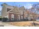 Side angle of a brick and siding home showing manicured landscaping, windows and architectural details at 6142 Golf View Xing, Locust Grove, GA 30248