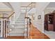 Welcoming foyer with hardwood floors and a staircase leading to the upper level of the house at 6142 Golf View Xing, Locust Grove, GA 30248