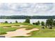 Scenic golf course view with sand traps, lush green grass, and lake views at 6142 Golf View Xing, Locust Grove, GA 30248