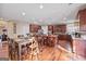 Spacious kitchen and dining area featuring dark wood cabinets, granite countertops, and ample seating at 6142 Golf View Xing, Locust Grove, GA 30248