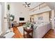 Spacious living room features soaring ceilings, cozy seating, fireplace, and ample natural light at 6142 Golf View Xing, Locust Grove, GA 30248