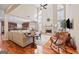 Open-concept living area with fireplace, wooden floors, comfortable seating, and seamless flow to the kitchen at 6142 Golf View Xing, Locust Grove, GA 30248