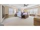 Spacious main bedroom boasts large windows, a ceiling fan, and a sitting area with comfortable furniture at 6142 Golf View Xing, Locust Grove, GA 30248