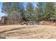 Outdoor area with rock water feature and retaining wall surrounded by pine trees at 6142 Golf View Xing, Locust Grove, GA 30248