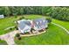 Expansive aerial view of the white home with a large backyard and a pool surrounded by black fencing at 310 Trestle Rd, Locust Grove, GA 30248