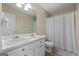Bathroom featuring a double sink vanity and a shower tub combination with a white shower curtain at 310 Trestle Rd, Locust Grove, GA 30248