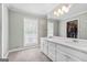 Bright bathroom featuring double sinks, white cabinetry, and a large mirror at 310 Trestle Rd, Locust Grove, GA 30248