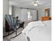 Spacious bedroom featuring a wicker rocking chair, closet, and dresser at 310 Trestle Rd, Locust Grove, GA 30248