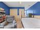 Stylish bedroom with blue accent wall, comfortable seating, and ample closet space at 310 Trestle Rd, Locust Grove, GA 30248
