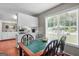 View of kitchen and breakfast nook with tile-topped table and ample natural light at 310 Trestle Rd, Locust Grove, GA 30248