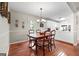 A dining room featuring a hardwood floor, with easy access to the kitchen area at 310 Trestle Rd, Locust Grove, GA 30248